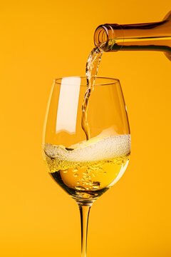 Wine bottle pouring withe wine into glass isolated on yellow background. Vertical Shot Generative AI