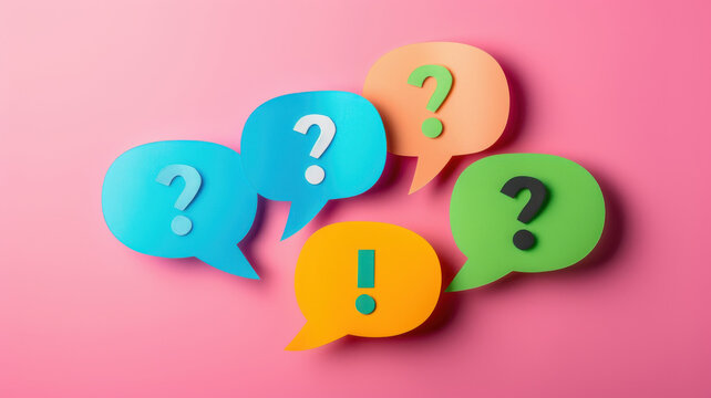 Colorful speech bubbles with question marks and exclamation points on a pink background, symbolizing communication and inquiry.