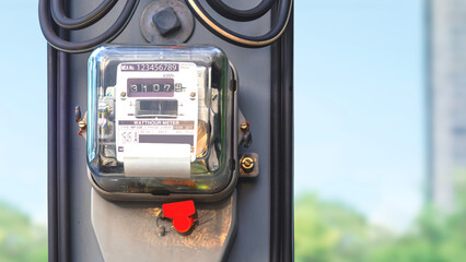 Electricity meter on electric power pole with cable line and blurred outdoor background, close up...