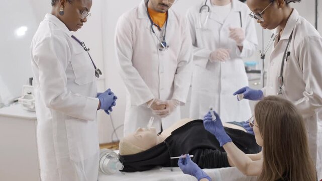 Participants engage in first aid training, practicing techniques on a medical mannequin