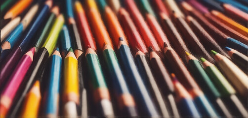 illustrative and colorful illustration of crayons and pencils in bright colors on white paper