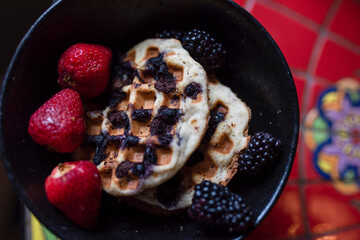 gluten free waffles with fruit on the side of the bowl