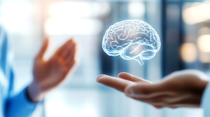 A digital brain hologram projected between hands, symbolizing innovation and technology in neuroscience and artificial intelligence.