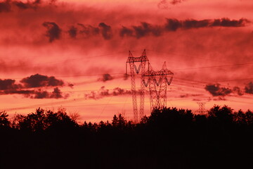 electricity transport tower on red sky