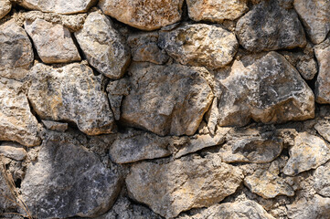 ancient stone wall close-up sun rays