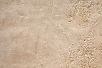 A textured wall with a warm earthy tone