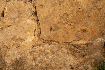 A textured stone wall weathered by time and the elements