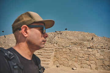 Young men exploring archaeological site of the Sacred City of Caral, Peru.