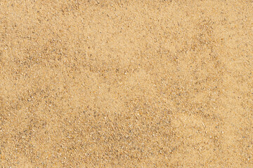 Beige beach sand background or texture. Copy space, top view.