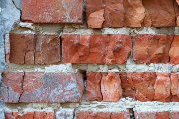 red old brick wall background, brick wall texture, structure. old broken brick, cement joints,...