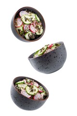 Seaweed radish cucumber salad in a bowl on a white isolated background