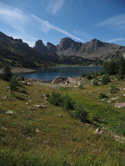 Alpine stream flowing through a green valley with rocky mountain peaks