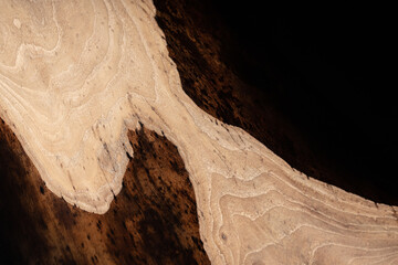 Expensive vintage furniture. The table is covered with epoxy resin and varnished. Luxury quality wood processing. Wooden table on a dark background. Black river made of epoxy resin.