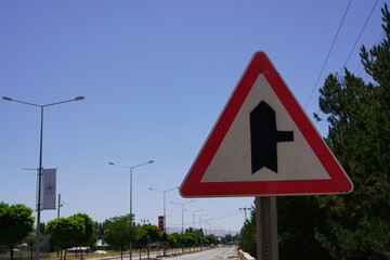 A merge right sign, a metaphor for life's transitions, guides traffic on a road, symbolizing...