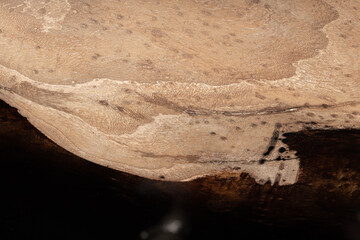 Expensive vintage furniture. The table is covered with epoxy resin and varnished. Luxury quality wood processing. Wooden table on a dark background. Black river made of epoxy resin.