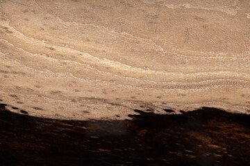 Expensive vintage furniture. The table is covered with epoxy resin and varnished. Luxury quality wood processing. Wooden table on a dark background. Black river made of epoxy resin.