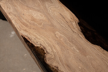 Expensive vintage furniture. The table is covered with epoxy resin and varnished. Luxury quality wood processing. Wooden table on a dark background. Black river made of epoxy resin.