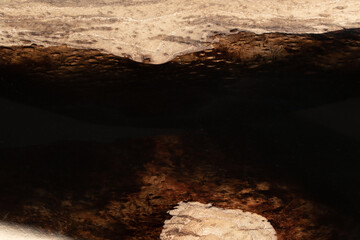 Expensive vintage furniture. The table is covered with epoxy resin and varnished. Luxury quality wood processing. Wooden table on a dark background. Black river made of epoxy resin.