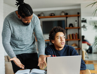 father child home family homework son teenage parent education arguing bored tired refusing annoyed...