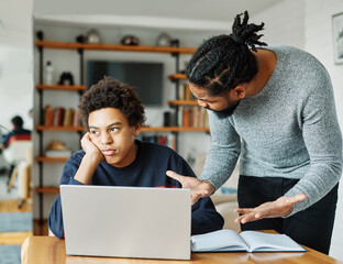 father child home family homework son teenage parent education arguing bored tired refusing annoyed...