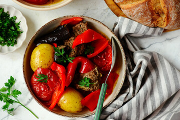 Cutlets with vegetables in a cauldron in Azerbaijani style.