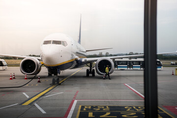 Airplane Refueling and Maintenance with Safety Cones on Airport Tarmac