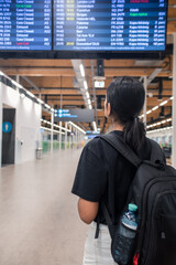 Traveler at Airport Checking Mobile Phone and Flight Details Before Departure