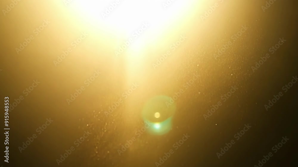 Poster As the camera moves closer the sunlight filters through a dusty window capturing the gentle twirl of particles illuminated against a dark backdrop creating a beautiful contrast.