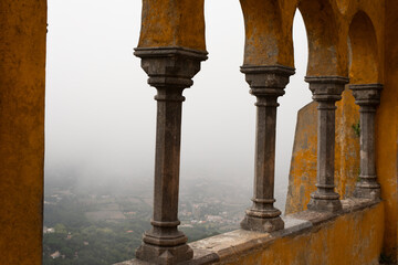 Fototapeta premium A misty view from a castle balcony showcasing intricate stonework
