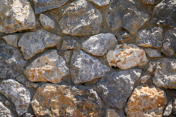 Old beige stone wall background texture