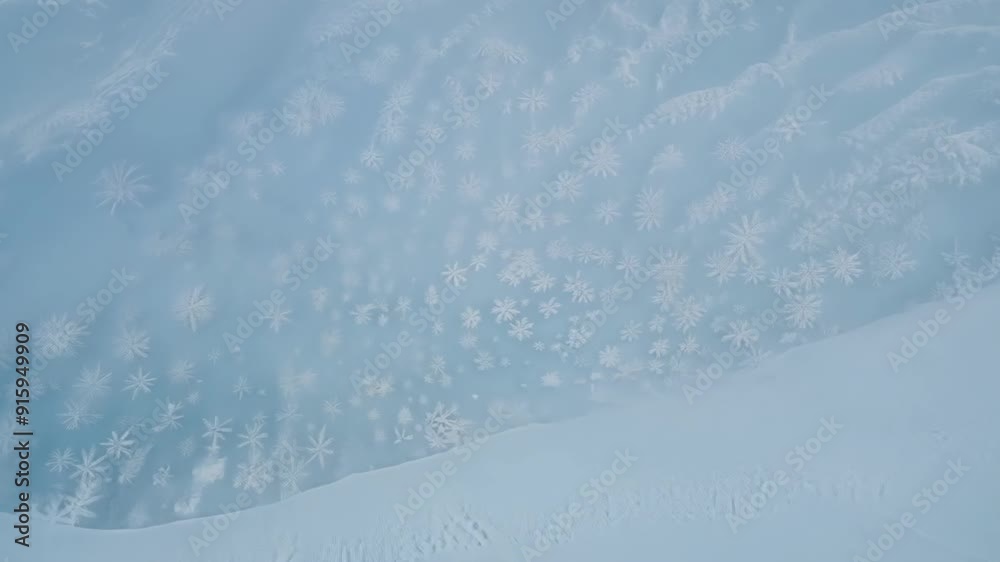 Poster Zooming in on the untouched snow the camera captures the delicate curves and ripples left by the gusts of wind creating striking snow drift patterns.
