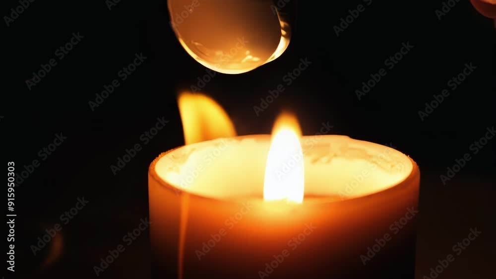 Poster Tight shot of a candle flame being snuffed out with a candle snuffer resulting in the sudden disappearance of light and warmth.