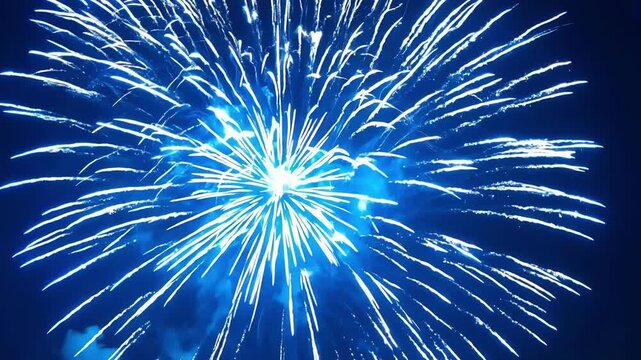 A closeup of a deep blue firework reveals the inner combustion as it explodes creating a stunning display of light and color.