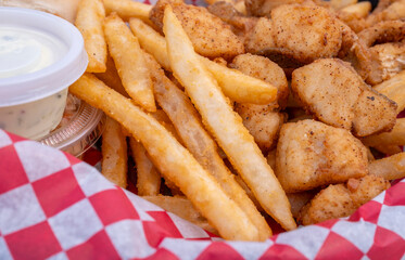 Deep Fried and lightly Battered Pickerel Nuggets Served with Fries, Tartar Sauce and Coleslaw