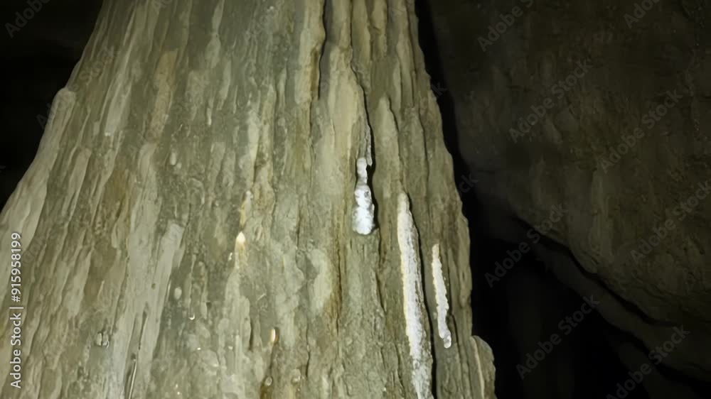 Poster A closeup shot of a large stalagmite with its pointed tip reaching towards the ceiling of the cave revealing the slow and steady process of mineral formation.