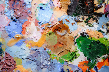 Colorful abstract texture. Smears of oil paint and a palette knife on an art palette. The concept...