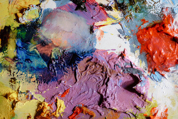Colorful abstract texture. Smears of oil paint and a palette knife on an art palette. The concept...