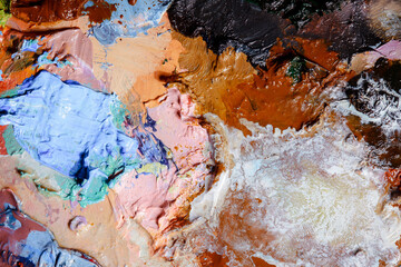Colorful abstract texture. Smears of oil paint and a palette knife on an art palette. The concept...
