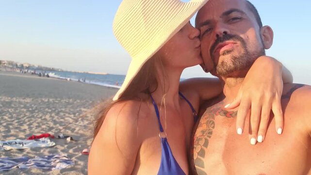 Romantic couple doing selfies at the beach
