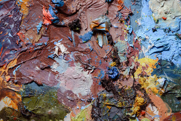 Colorful abstract texture. Smears of oil paint and a palette knife on an art palette. The concept...