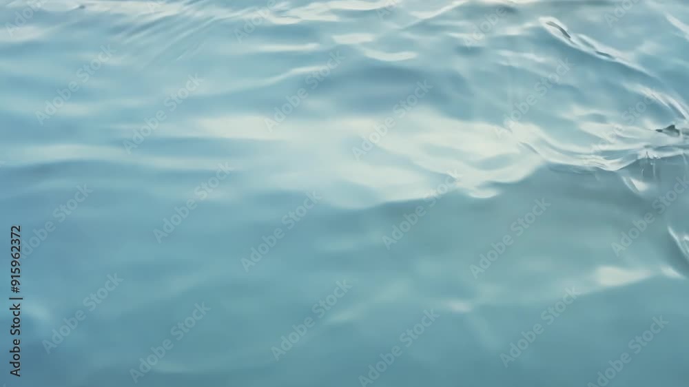 Aufkleber Soft and gentle ripples cascade across the glassy water surface creating a mesmerizing display.
