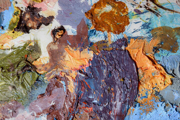 Colorful abstract texture. Smears of oil paint and a palette knife on an art palette. The concept...