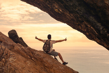 Hiker with arms up on the top of the mountain - Successful man enjoying triumph - Sport and success concept
