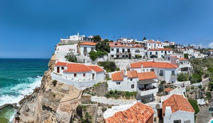 A charming whitewashed village perched on a cliff overlooking the ocean