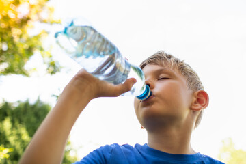 child drinking water from bottle