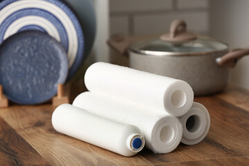 Water filters on wooden table in kitchen