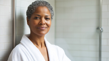 Portrait of African-American matue woman in white bath robe, daily spa and wellness care, copy space
