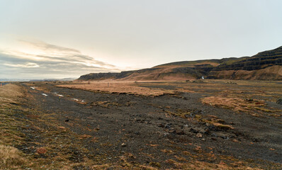 Rugged landscape dominating the volcanic icelandic plains at sunset