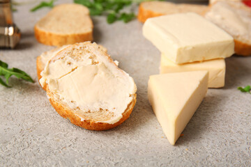 Sandwiches with processed cheese and herbs on grunge background