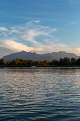 Beautiful evening at the shores of Chiemseestrand in Bavaria. The calm lake, colorful sky, and perfect weather create an incredible atmosphere.